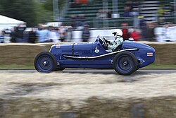 Bira's 1936 Maserati 8CM, seen in his original all blue livery with Siamese flags on the tail and the White Mouse emblem just ahead of the cockpit