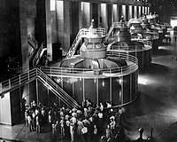 Tourists gather around one of the generators in the Nevada wing of the powerhouse to hear its operation explained, September 1940.
