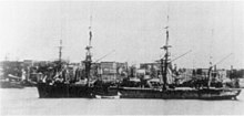 A three-masted ship with dark sides and a flared prow
