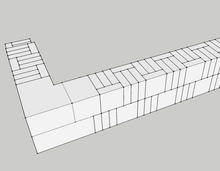 A 3D model of a brick wall showcasing a line of bricks. Demonstrates the header against stretcher ashlar construction technique in Phoenician masonry.