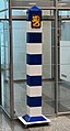 Finnish border marker in the immigration hall of Helsinki-Vantaa Airport. Notable for its castors and thus a somewhat unique mobile boundary marker.