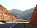 I-15 southbound at milepost 17.8—afternoon sun in a bright red rock cut
