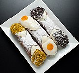 Cannoli with pistachio, candied fruit, and chocolate chips