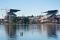 Husky Stadium, University of Washington, seen across Union Bay. The original stands were built 1920 by the Puget Sound Bridge and Dredging Company; major modifications included the cantilevered covered south stands (1950), similar stands on the north side (1987), and the major reconstruction 2011–2013, in progress in this photo.