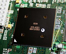 A microprocessor chip with the word "Sega" on it, on a circuit board.