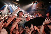 Crowd surfing at a concert (France, 2011)