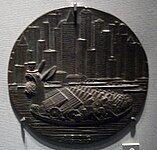 An unsympathetic later medal, also by Gies. Shows ship as a monster packed with weapons, mouth full of coins.