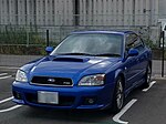 Subaru Legacy S401 STI Version, a high-performance variant of the standard Subaru Legacy sedan. This photo shows the front of the car, which is blue; there is a "S401" badge on the front grille.