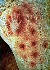 Image of a human hand created with red ochre in Pech Merle cave, France (Gravettian era, 25,000 BC).