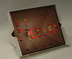 A Lite-Brite (without black paper) spelling "Hello"