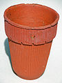 Herty turpentine cup, made of clay. The hole is for nailing to a pine tree