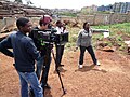 Image 9Filmmaker Nathan Collett (with camera) shooting feature film Togetherness Supreme in collaboration with Kibera youth trainees. (from Culture of Kenya)