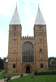 Southwell Cathedral, England, 1120, follows the Norman model with pyramidal spires as were probably at Saint-Étienne. The Perpendicular window and battlement are late Gothic.