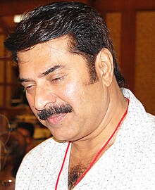 Close-up shot of Mammootty, who is looking downwards
