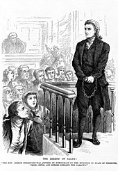 Engraving in black ink on white paper of a manacled, adult white man dressed in black defiantly facing a crowd of onlookers in a courtroom