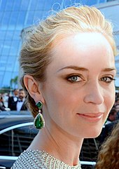 A side face shot of Emily Blunt as she looks towards the camera