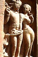 Male and female statues wearing drapes at Nachna Hindu temples.