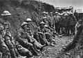 Irish soldiers in Service Dress uniforms wait in a trench at the Somme, on the Western Front.