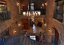 Interior of a large building with a staircase and elevator