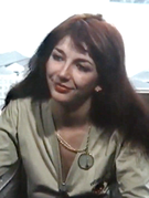 Kate Bush smiling and looking to her right