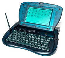 A bulbous, plastic-shelled computer, with a keyboard at the bottom and a computer screen above it on a hinge.