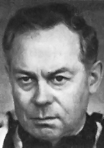 Black and white headshot photo of Starovoytov in a jacket and dress shirt.