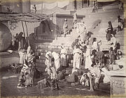Women and children bathing and collecting water at a ghat in Banares (Varanasi), the holy Hindu city on the banks of the Ganges river in northern India, 1885