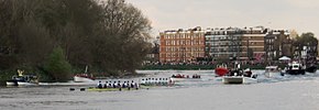 Two rowing eights rounding the last bend of the race course on the River Thames