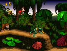 From a side-scrolling perspective, Diddy Kong jumps in a jungle-themed level. Donkey Kong trails behind him to the left, while a Kremling enemy hobbles away from him on the right.