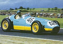 Bira driving his 1954 Maserati 250F in the 1954 French Grand Prix. The adaptations to the official racing scheme needed for post-WWII cars that lacked visible chassis rails are clearly seen: the yellow now forms a broad band around the lower part of the car's bodywork