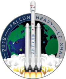 Artistic depiction of a Falcon heavy rocket launching from the Earth, represented in the background by a circular patch.