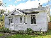 A railway cottage in Morea, Lower Hutt with a sunroom renovation on the porch.