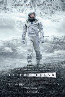 An astronaut on a cold mountain setting with snow falling with another mountain as a ceiling. Four of the actors names appear on the top, with a headline reading "The End of Earth will Not be the End of Us." Above the film's title, text reads "A film by Christopher Nolan", and credits are printed on the bottom.